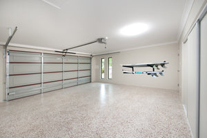 Wall mounted surfboard racks in garage powder coated black to hold 2 surfboards or mal